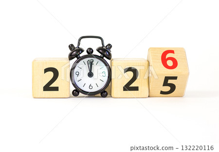 Business concept of 2026 new year symbol. Beautiful turned wooden cube and changed number 2025 to 2026. Black alarm clock. Beautiful white background, copy space. Business 2026 happy new year concept. Business concept of 2026 new year symbol. Beautiful turned wooden cube and changed number 2025 to 2026. Black alarm clock. Beautiful white background, copy space. Business 2026 happy new year concept. 132220116