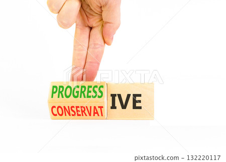 Progressive or conservative symbol. Businessman turns wooden cubes and changes word Conservative to Progressive. Beautiful white background. Business progressive or conservative concept. Copy space. Progressive or conservative symbol. Businessman turns wooden cubes and changes word Conservative to Progressive. Beautiful white background. Business progressive or conservative concept. Copy space. 132220117