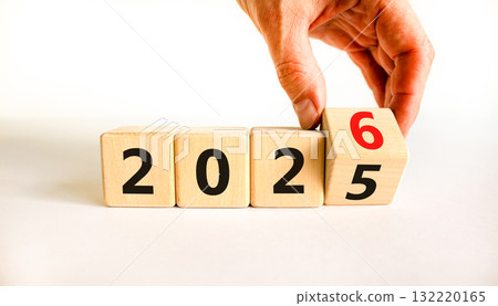 Business concept of 2026 new year symbol. Businessman turns wooden cube and changes number 2025 to 2026. Beautiful white table white background, copy space. Business 2026 happy new year concept. Business concept of 2026 new year symbol. Businessman turns wooden cube and changes number 2025 to 2026. Beautiful white table white background, copy space. Business 2026 happy new year concept. 132220165