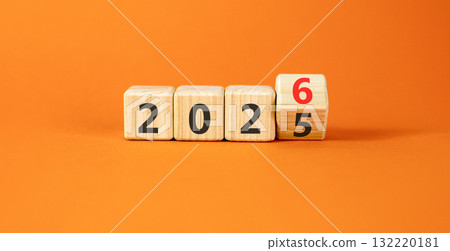 Business concept of 2026 new year symbol. Beautiful turned wooden cube and changed number 2025 to 2026. Beautiful orange table orange background, copy space. Business 2026 happy new year concept. 132220181