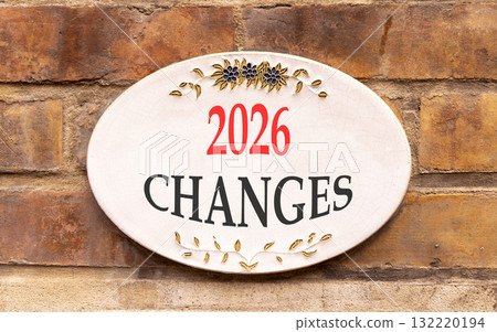 2026 Changes symbol. Concept words 2026 Changes on beautiful white sign. Beautiful old brown brick wall background. Business and 2026 changes concept. Copy space. 132220194
