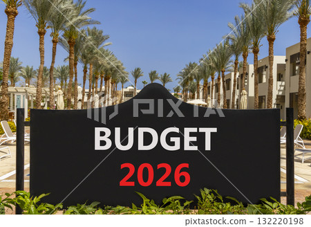 Budget 2026 symbol. Concept words Budget 2026 on beautiful black road sign. Beautiful palm trees palm-trees and blue sky background. Business and budget 2026 concept. Copy space. 132220198
