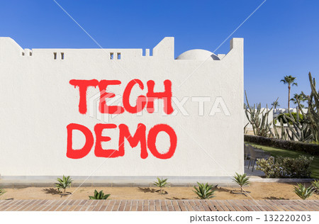 Tech demo symbol. Concept word Tech demo on beautiful white wall. Beautiful blue sky background. Business tech demo concept. Copy space. 132220203