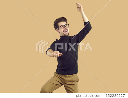Happy attractive young man is dancing, having fun and fooling around. Happy attractive young man is dancing, having fun and fooling around. 132220227
