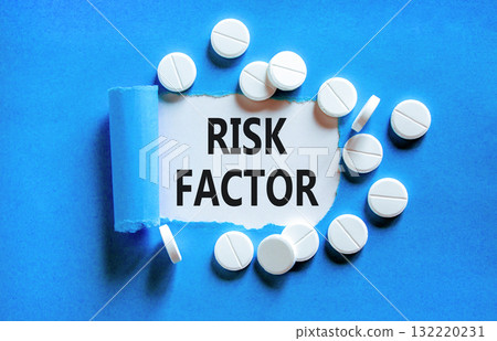 Risk factor symbol. Concept words Risk factor on beautiful white paper. White pills tablets. Beautiful blue background. Medical healthy lifestyle risk factor concept. 132220231