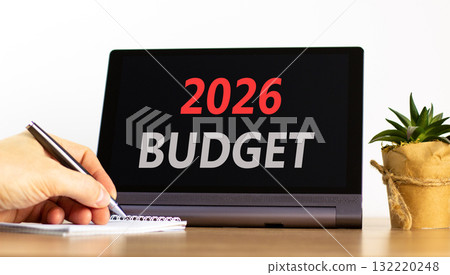 2026 Budget symbol. Concept words 2026 Budget on beautiful black tablet screen. Beautiful white background. Businessman's hand. Business and 2026 budget concept. Copy space. 132220248