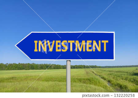 Investment symbol. Concept word Investment on beautiful blue road sign. Beautiful blue sky green grass and forest peaceful nature background. Business investment concept. Copy space. Investment symbol. Concept word Investment on beautiful blue road sign. Beautiful blue sky green grass and forest peaceful nature background. Business investment concept. Copy space. 132220258