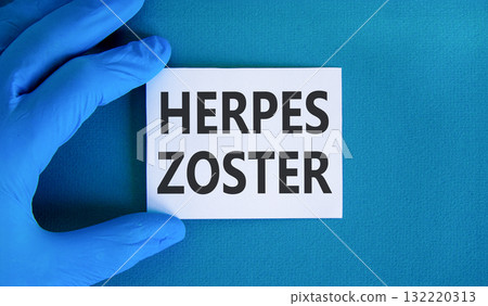 Herpes zoster symbol. Concept words Herpes zoster on beautiful white card. Doctor's hand in blue medical glove. Beautiful blue background. Medical healthy lifestyle herpes zoster concept. Herpes zoster symbol. Concept words Herpes zoster on beautiful white card. Doctor's hand in blue medical glove. Beautiful blue background. Medical healthy lifestyle herpes zoster concept. 132220313