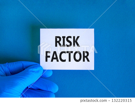 Risk factor symbol. Concept words Risk factor on beautiful white card. Doctor's hand in blue medical glove. Beautiful blue background. Medical healthy lifestyle risk factor concept. 132220315