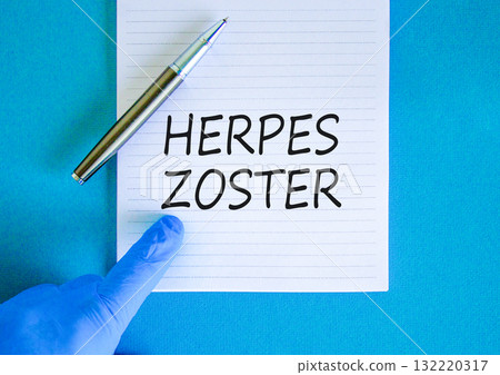 Herpes zoster symbol. Concept words Herpes zoster on beautiful white note. Doctor's hand in blue medical glove. Black pen. Beautiful blue background. Medical healthy lifestyle herpes zoster concept Herpes zoster symbol. Concept words Herpes zoster on beautiful white note. Doctor's hand in blue medical glove. Black pen. Beautiful blue background. Medical healthy lifestyle herpes zoster concept 132220317