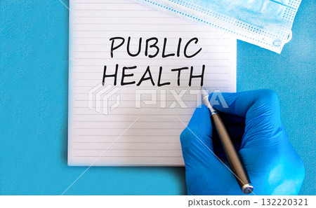 Public health symbol. Concept words Public health on beautiful white note. Doctor's hand in blue medical glove. Medical mask. Beautiful blue background. Medical healthy lifestyle public health concept Public health symbol. Concept words Public health on beautiful white note. Doctor's hand in blue medical glove. Medical mask. Beautiful blue background. Medical healthy lifestyle public health concept 132220321