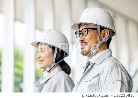 Men and women in work clothes investigating the scene Men and women in work clothes investigating the scene 132220935