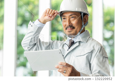 Site supervisor looking at tablet Site supervisor looking at tablet 132220952