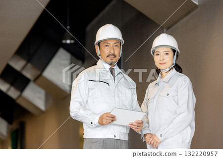 Workers with tablets Workers with tablets 132220957