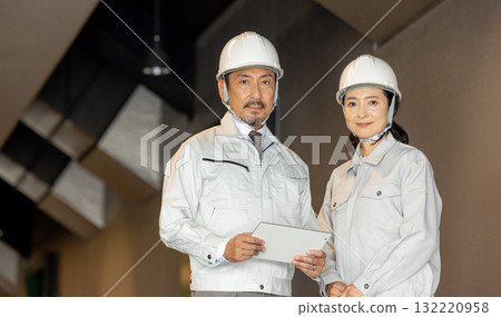Workers with tablets Workers with tablets 132220958