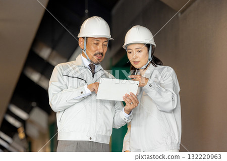 Workers with tablets Workers with tablets 132220963