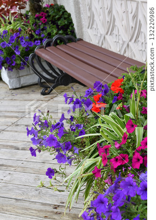 Flowers in a vase and bench near the house Flowers in a vase and bench near the house 132220986