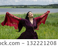 Portrait of a middle-aged shaman woman with a red headscarf 132221208