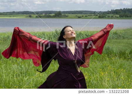 Portrait of a middle-aged shaman woman with a red headscarf 132221208