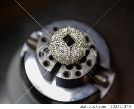 Intricate metal design on a manufacturing tool showcasing craftsmanship 132221349