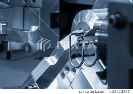 Close up scene operation of the coil spring making machine. Close up scene operation of the coil spring making machine. 132223287