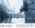 Close up scene the CNC lathe machine finishing process the metal shaft parts in the blue tone scene. 132223293