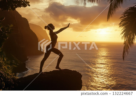Silhouette of a Woman Practicing Yoga on a Rocky Shore at Sunset by the Ocean 132224667
