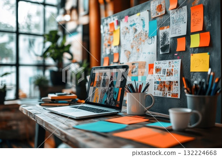 Creative workspace with laptop, sticky notes, coffee cup, and art inspiration board Creative workspace with laptop, sticky notes, coffee cup, and art inspiration board 132224668