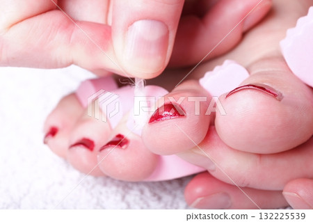 female feet red polished nails 132225539