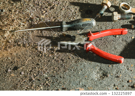 Pliers, wrench screwdriver on floor. 132225897