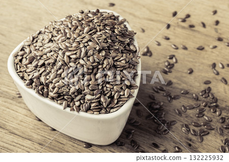 Flax seeds linseed in bowl on wooden table Flax seeds linseed in bowl on wooden table 132225932