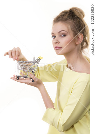 Woman holding small shopping cart 132226020