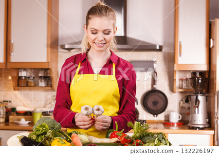 Woman holding two garlic 132226197