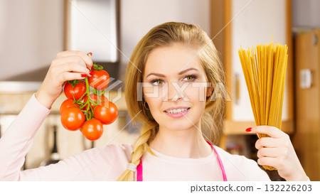 Woman holding pasta and tomatoes 132226203