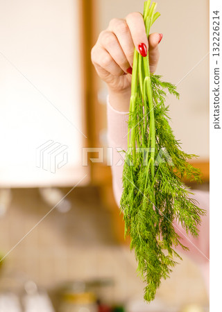 Woman holding green dill herb Woman holding green dill herb 132226214