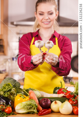 Woman holding two garlic Woman holding two garlic 132226238