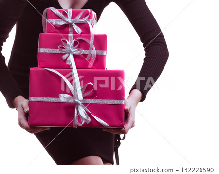 Girl carrying many pink gift boxes Girl carrying many pink gift boxes 132226590