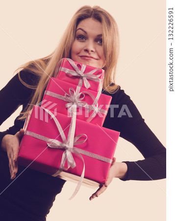 Happy surprised woman with many gifts 132226591