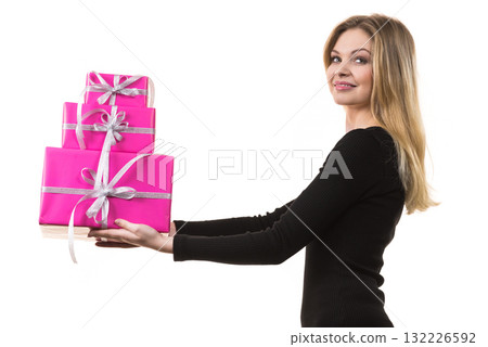Girl holding stack of pink gift boxes Girl holding stack of pink gift boxes 132226592