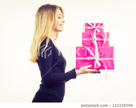 Elegant woman holding gift boxes Elegant woman holding gift boxes 132226594