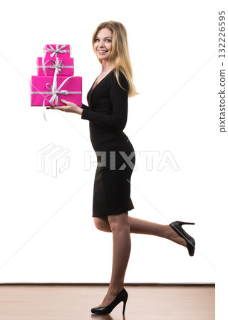 Girl holding stack of pink gift boxes Girl holding stack of pink gift boxes 132226595
