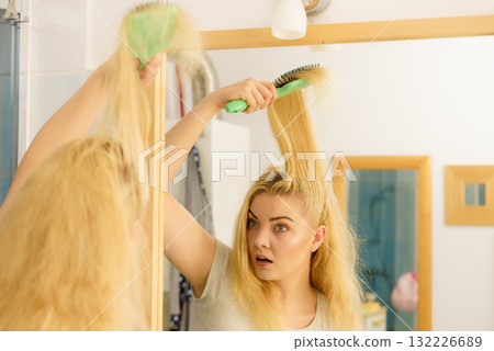 Sad woman brushing hair Sad woman brushing hair 132226689