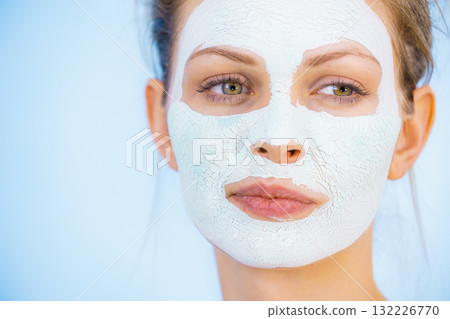 Girl with dry white mud mask on face Girl with dry white mud mask on face 132226770