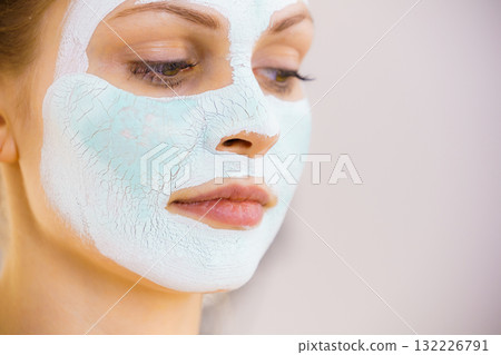 Girl with white green mud mask on face Girl with white green mud mask on face 132226791