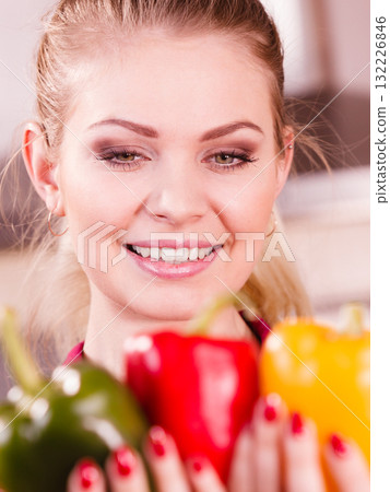 Happy woman holding bell peppers paprika 132226846