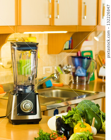 Smoothie mixer maker next to vegetables 132226847