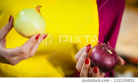 Woman holding red and white onion Woman holding red and white onion 132226852
