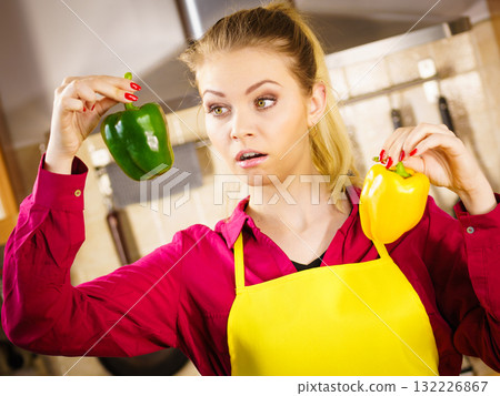 Woman holding bell peppers paprika thinking Woman holding bell peppers paprika thinking 132226867