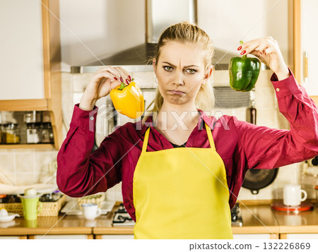 Woman holding bell peppers paprika thinking Woman holding bell peppers paprika thinking 132226869