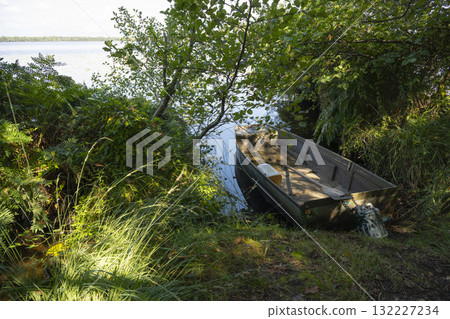Peaceful barque at Lac de Leon, surrounded by nature's beauty 132227234